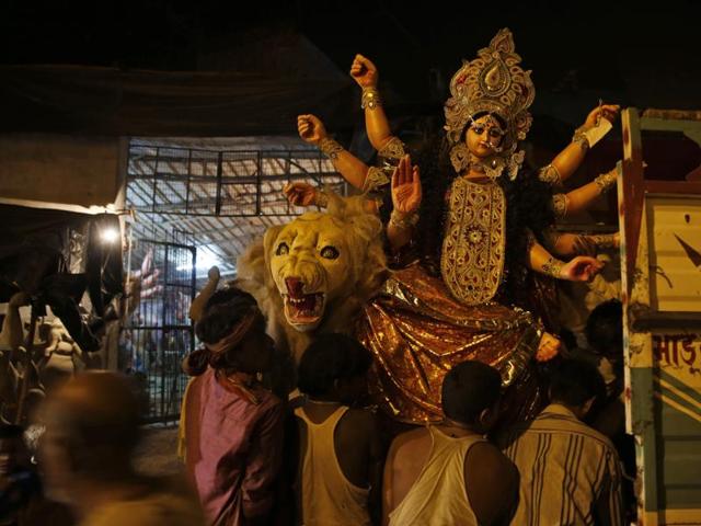 Laborers load an idol of Durga onto a truck ahead of Navratri in Allahabad. (AP)
