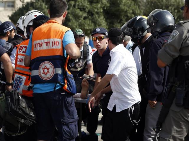 Israeli medics wheel away an injured female Palestinian attacker (C) on a stretcher in Jerusalem on October 12, 2015, following a stabbing attack Israeli police said she carried out near the police headquarters in the holy city. (AFP Photo) Israeli medics wheel away an injured female Palestinian attacker (C) on a stretcher in Jerusalem on October 12, 2015, following a stabbing attack Israeli police said she carried out near the police headquarters in the holy city. (AFP Photo)