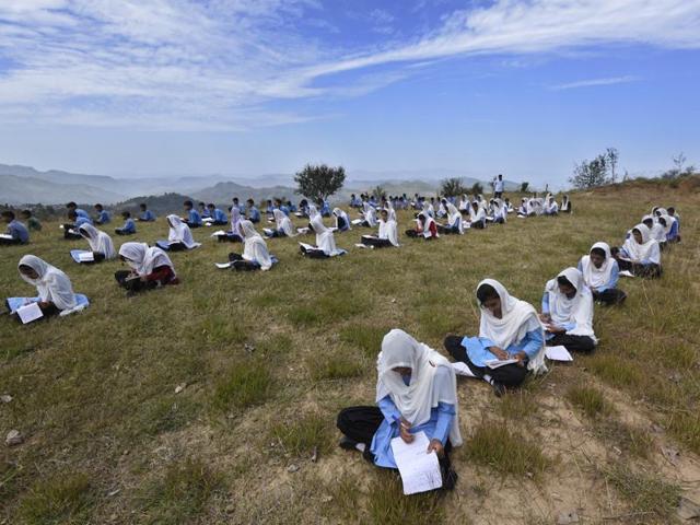 Students of the army-run Pinewood School in Hamirpur area of Bhimber Gali write an exam in open ground, with hills in PoK in the backdrop. (Gurinder Osan/HT Photo) Students of the army-run Pinewood School in Hamirpur area of Bhimber Gali write an exam in open ground, with hills in PoK in the backdrop. (Gurinder Osan/HT Photo)