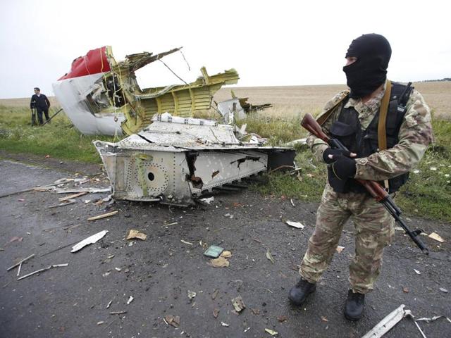 A pro-Russian separatist stands at the crash site of Malaysia Airlines flight MH17.(REUTERS) A pro-Russian separatist stands at the crash site of Malaysia Airlines flight MH17.(REUTERS)