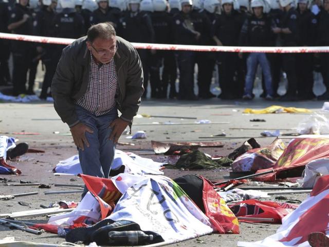 A man stands over the body of a victim at the scene of an explosion in Ankara, Turkey. The two bomb explosions targeting a peace rally in the capital Ankara has killed dozens of people and injured scores of others. (AP Photo) A man stands over the body of a victim at the scene of an explosion in Ankara, Turkey. The two bomb explosions targeting a peace rally in the capital Ankara has killed dozens of people and injured scores of others. (AP Photo)