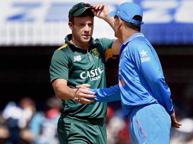 Indian captain MS Dhoni shakes hands with South African captain AB de Villiers during the toss. (PTI Photo)