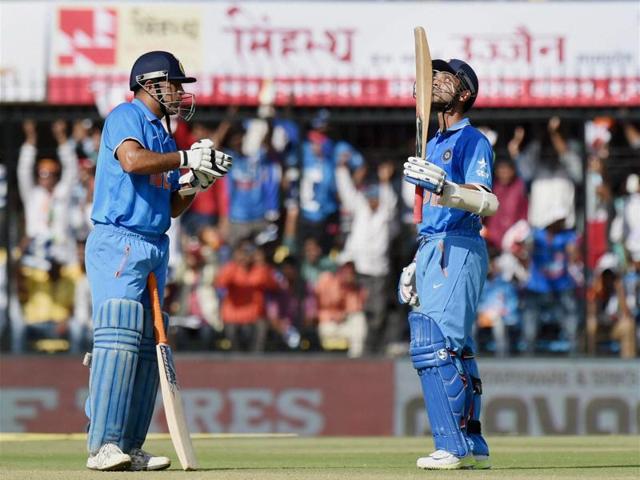 Ajinkya Rahane celebrates his half century with MS Dhoni. ) (PTI Photo)