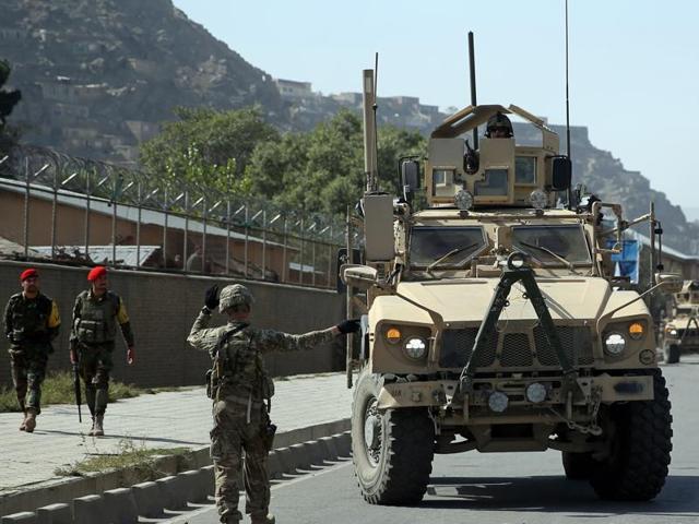 A US soldier directs his colleague at the site of a bomb attack that targeted several armoured vehicles belonging to forces attached to the NATO Resolute Support Mission, in downtown of Kabul, Afghanistan. (AP Photo) A US soldier directs his colleague at the site of a bomb attack that targeted several armoured vehicles belonging to forces attached to the NATO Resolute Support Mission, in downtown of Kabul, Afghanistan. (AP Photo)