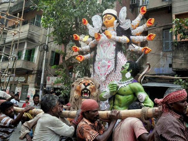 People carry a Goddess Durga idol towards a puja pandal in Kolkata. (PTI photo) People carry a Goddess Durga idol towards a puja pandal in Kolkata. (PTI photo)