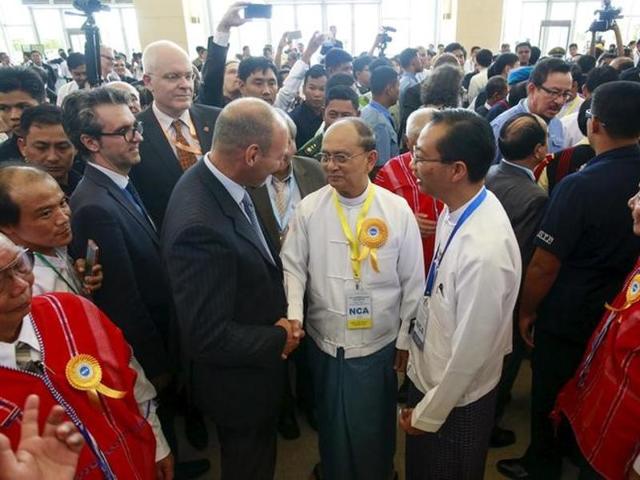 Myanmar's President Thein Sein (with yellow ribbon) greets international witnesses after the signing ceremony of the Nationwide Ceasefire Agreement (NCA) in Naypyitaw, Myanmar. (AFP) Myanmar's President Thein Sein (with yellow ribbon) greets international witnesses after the signing ceremony of the Nationwide Ceasefire Agreement (NCA) in Naypyitaw, Myanmar. (AFP)