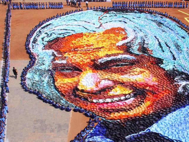 Indian school students surround a giant portrait of former President APJ Abdul Kalam as they celebrate his birth anniversary at a school in Chennai. (AP Photo)