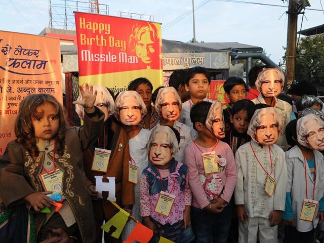 Children pay tribute to former President APJ Abdul Kalam on his birthday by wearing his mask during a programme organised by NGO Search and research development society in Bhopal. (Praveen Bajpai/Ht Photo)
