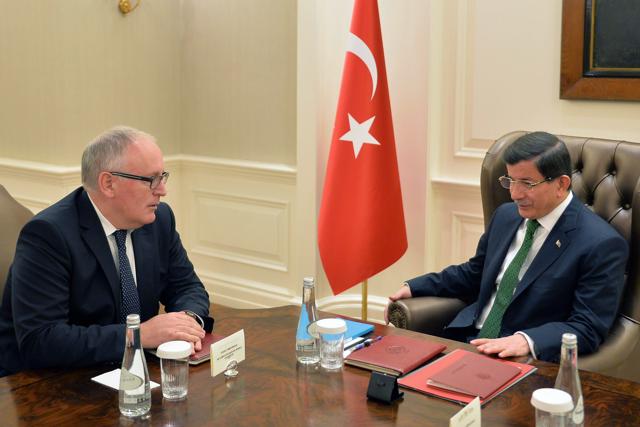 Turkish Prime Minister Ahmet Davutoglu (R) and European Commission's vice-president Frans Timmermans hold a meeting in Ankara. Turkey and the EU have agreed to a new deal on the migration crisis. (AFP)
