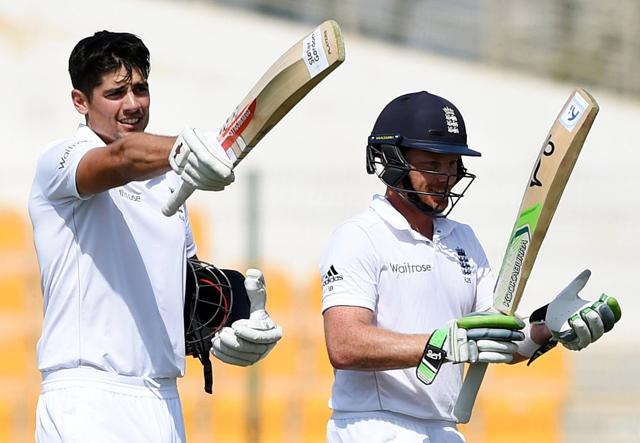 England captain Alastair Cook, left, standing next to teammate Ian Bell, waves his bat after reaching a century during the third day of the first test match against Pakistan. The England skipper would end the fourth day with a double century. (AP Photo)