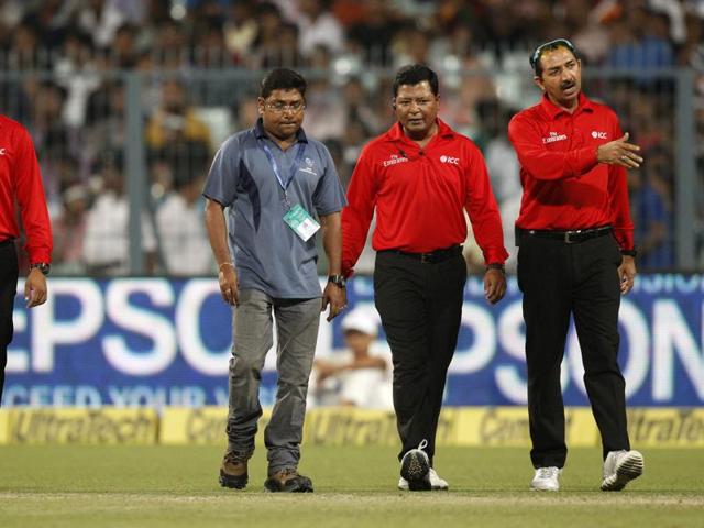 Umpires Anil Chaudhary, right, Vineet Kulkarni, left, and Chettithody Shamshuddin, second right, inspect the wet ground in Kolkata. (AP Photo) Umpires Anil Chaudhary, right, Vineet Kulkarni, left, and Chettithody Shamshuddin, second right, inspect the wet ground in Kolkata. (AP Photo)