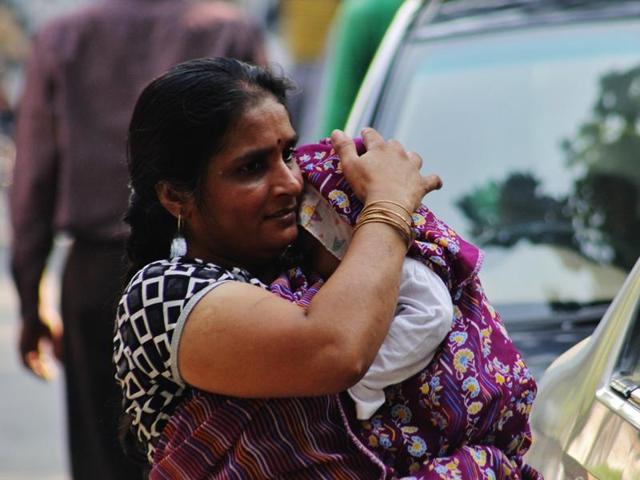 A woman protects a baby from the heat in Thane on Friday.   (Praful Gangurde)