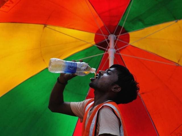 Mumbai sweltered at 38.6 degrees Celsius – the highest-ever recorded day temperature for October. A worker takes a break from the heat on Friday. (Praful Gangurde)