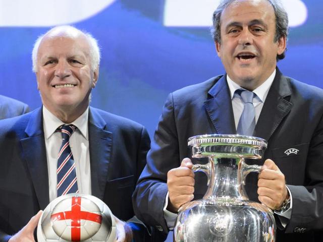 In this file photo, Uefa president Michel Platini (R) shows The Henri Delaunay trophy of the Uefa European Football Championship next to Britain's Greg Dyke, chairman of The Football Association (FA). Michel Platini lost England's support for his Fifa presidential bid.(AP File Photo)