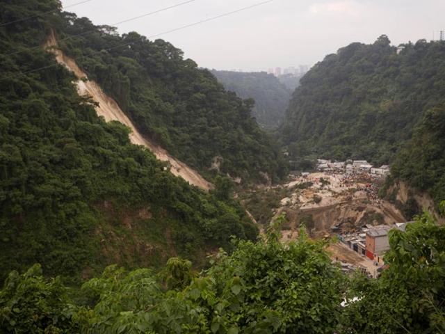 Rescue workers search for survivors after a landslide hit Cambray, a neighbourhood in the suburb of Santa Catarina Pinula, about 10 miles east of Guatemala City. Hundreds are missing, with at least 36 dead after the landslide devastated the villages on the outskirts of Guatemala City. (AP Photo)