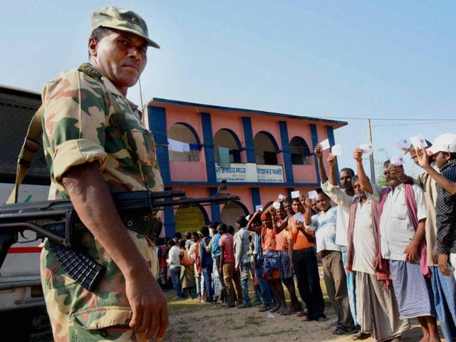Voters wait in queue to cast votes at a polling station in Gaya. Around 86 lakh voters will decide the fate of 456 candidates at 9,119 polling stations across Bihar. (PTI Photo)