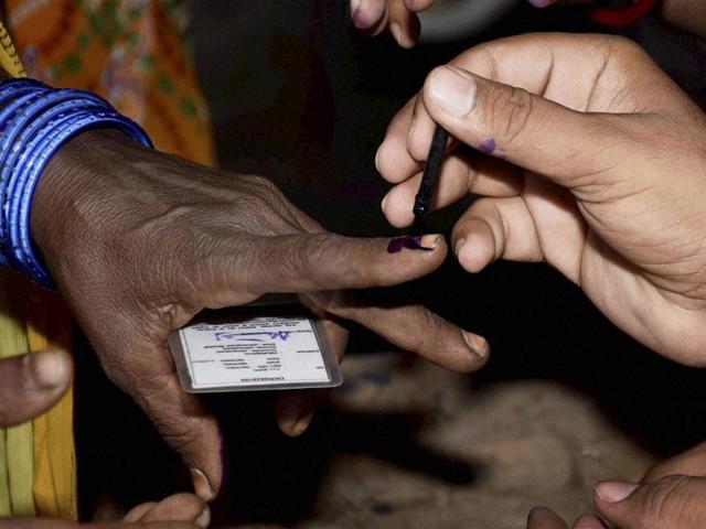 A polling officer puts the ink mark on a voter's finger at a polling station in Jehanabad. The second phase voting constitutes a great challenge for the security personnel as the six districts are heavily affected by Maoist movement. (PTI Photo)