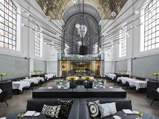 Designers at Piet Boon used the majestic backdrop of a former military hospital chapel to create a fine dining restaurant setting at The Jane in Antwerp. (AFP)