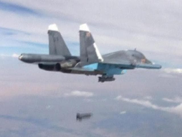A frame grab taken from footage released by Russia's defence ministry shows a Russian Su-34 fighter-bomber dropping a bomb in the air over Syria.(REUTERS) A frame grab taken from footage released by Russia's defence ministry shows a Russian Su-34 fighter-bomber dropping a bomb in the air over Syria.(REUTERS)