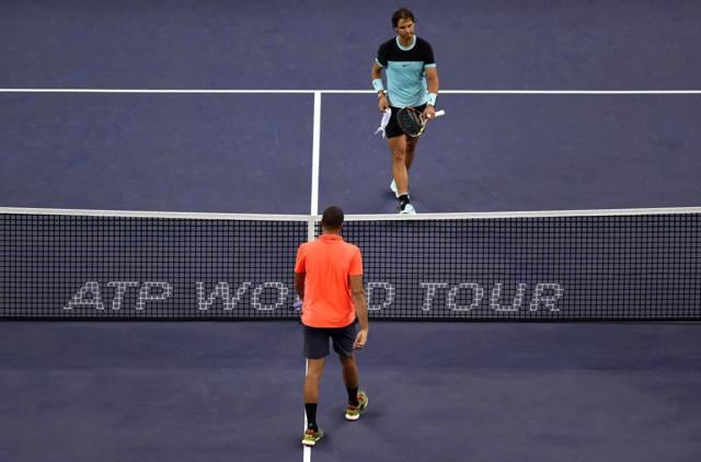 Jo-Wilfried Tsonga of France (bottom) and Rafael Nadal of Spain prepare to shake hands after their men's singles semi-final match against at the Shanghai Masters tennis tournament in Shanghai. (AFP Photo) Jo-Wilfried Tsonga of France (bottom) and Rafael Nadal of Spain prepare to shake hands after their men's singles semi-final match against at the Shanghai Masters tennis tournament in Shanghai. (AFP Photo)