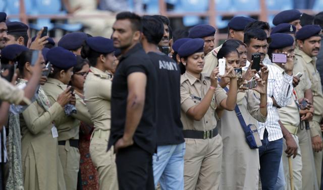 Police personal taking picture during the practice session on the eve of 3rd One Day international cricket match against South Africa at Saurashtra Cricket Association Stadium in Rajkot on Saturday, October 17, 2015. The city administration has turned the venue into a fortress with a heavy police presence. (Hindustan Times) Police personal taking picture during the practice session on the eve of 3rd One Day international cricket match against South Africa at Saurashtra Cricket Association Stadium in Rajkot on Saturday, October 17, 2015. The city administration has turned the venue into a fortress with a heavy police presence. (Hindustan Times)