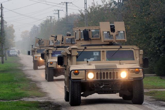 Hungarian soldiers patrol in their armoured vehicles through the village of Illocska at the Hungarian-Croatian border on October 17, 2015. The border between Hungary and Croatia has been closed to "illegal" migrants, the Hungarian government said, with barbed wire fences being set up to seal the frontier. (AFP)