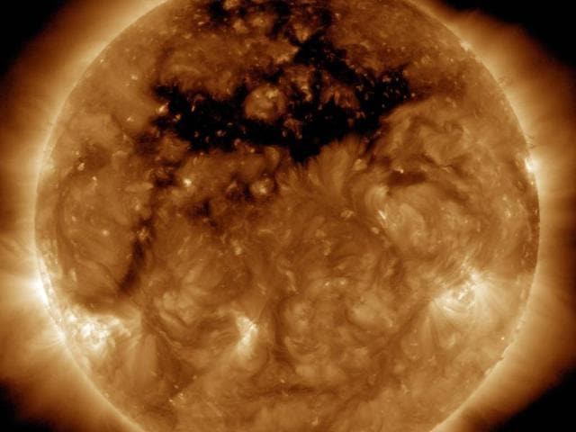 The dark area across the top of the sun in this image is a coronal hole, a region on the sun where the magnetic field is open to interplanetary space.(Picture courtesy: Nasa)