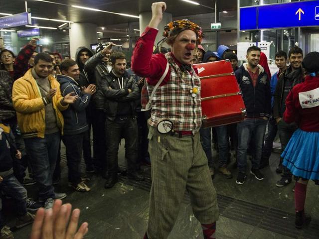 Members of the "Red Nose Clown doctors" perform for migrants at the Main Train Station in Vienna, Austria.(AFP Photo) Members of the "Red Nose Clown doctors" perform for migrants at the Main Train Station in Vienna, Austria.(AFP Photo)