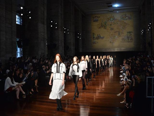 The collection featured attires almost entirely in shades of black, white, or black-and-white plaid. (AFP)