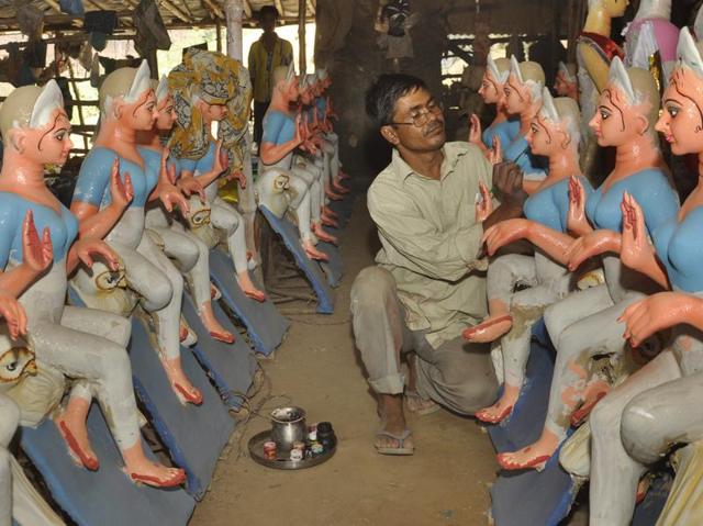 An artist prepares clay tableau of Goddess Durga in Ghaziabad. (Sakib Ali/HT Photo)