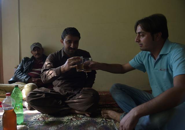 A local resident Rehmat Ali (R) and his cousin toast each other as they prepare to drink home brewed wine in the remote village of Sher Qilla in Punyal valley in northern Pakistan. (AFP) A local resident Rehmat Ali (R) and his cousin toast each other as they prepare to drink home brewed wine in the remote village of Sher Qilla in Punyal valley in northern Pakistan. (AFP)