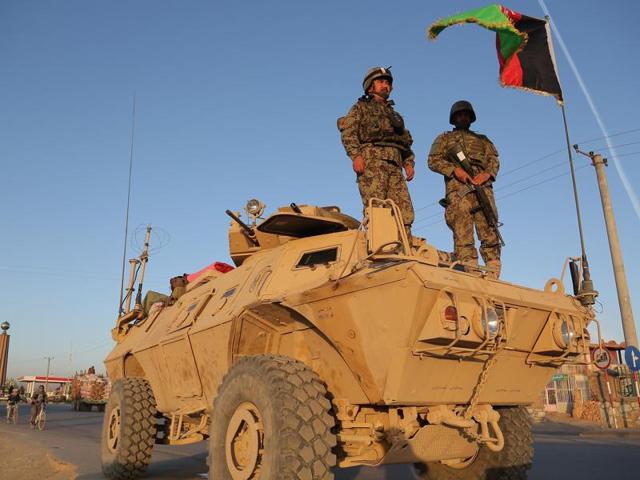 Afghan security personnel stand guard on an armoured vehicle at a checkpoint in Ghazni on October 13, 2015. The military occupation of Kunduz, a strategic link between Kabul and Dushanbe in Tajikistan, sent shock waves in the West, forcing US President Obama to commit 5,500 troopers on ground till 2017. (AFP Photo) Afghan security personnel stand guard on an armoured vehicle at a checkpoint in Ghazni on October 13, 2015. The military occupation of Kunduz, a strategic link between Kabul and Dushanbe in Tajikistan, sent shock waves in the West, forcing US President Obama to commit 5,500 troopers on ground till 2017. (AFP Photo)