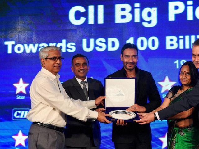 Ajay Devgan receiving a memento from CII officials during the CII Big Picture Summit 2015 in New Delhi on Monday. (PTI)