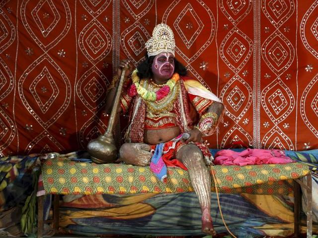An artist dressed as Hanuman waits for his turn to perform in Ramlila in Ahmedabad. (REUTERS)