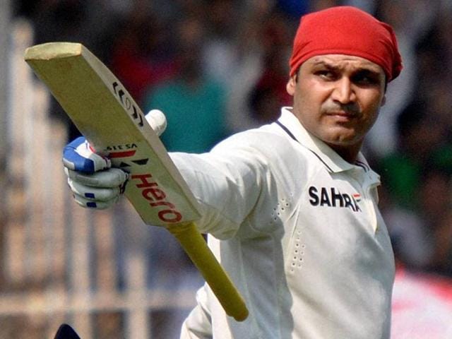 Virender Sehwag celebrates his century on the opening day of the first Test match against England in Ahmedabad, on November 15, 2012. (PTI Photo)