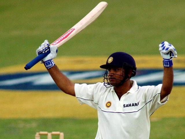Sehwag raises his arms in celebration after scoring a century on debut during the first Test against South Africa and India in Bloemfontein, South Africa, in 2001. (Getty Images)