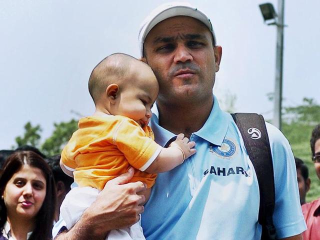 Sehwag with his son Aryavir at the Chennai Airport. (PTI Photo)
