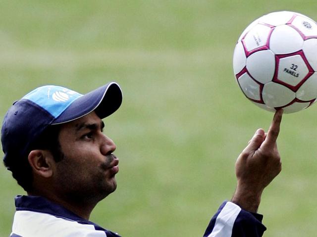 Sehwag spins a football on his finger during a training session in Melbourne, Australia. (AP Photo)