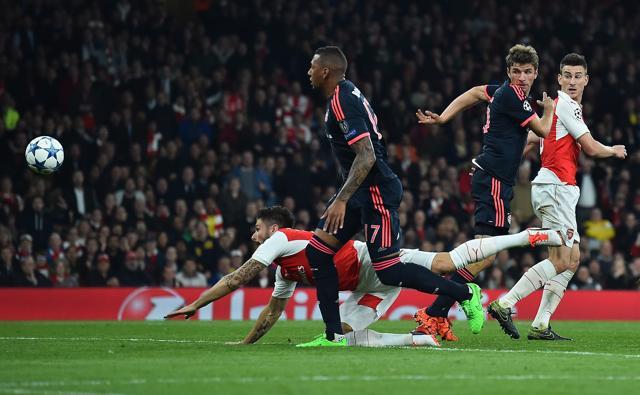 Olivier Giroud, left, dives to score Arsenal's first goal after Manuel Neuer’s blunder. (AFP)