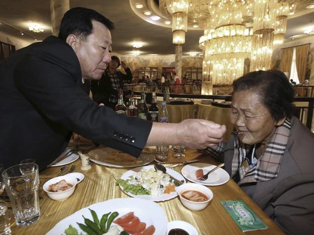 South Korean Park Mun-soo, 71, gives a food to his North Korean sister Pak Mun Gyong, 83, at a luncheon during the Separated Family Reunion Meeting at Diamond Mountain resort in North Korea. (AP Photo)