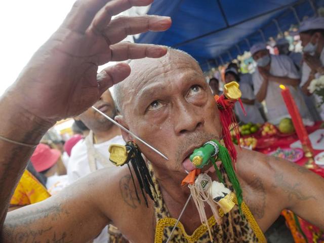 The most striking element of the nine-day celebration has little to do with food. In sacred rituals, devotees work themselves into trances to have all manner of items pierced through their cheeks, from daggers and swords to a bicycle. Then they dance as massive strings of fireworks explode all around them. (AP Photo/David Longstreath) (AP)