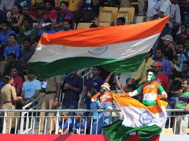 Indian fans wave the Indian flag as they cheer their team at the start of the match. (AFP Photo)
