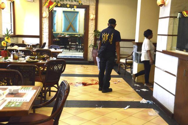 A police investigator surveys the blood-stained floor at the Lighthouse restaurant, where three Chinese diplomats were shot, in Cebu city, central Philippines. (Reuters Photo) A police investigator surveys the blood-stained floor at the Lighthouse restaurant, where three Chinese diplomats were shot, in Cebu city, central Philippines. (Reuters Photo)