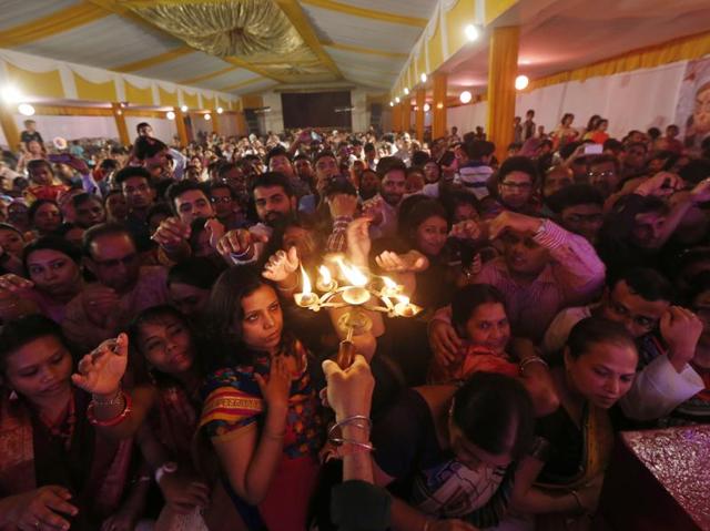 People celebrating Durga Puja at Kali-Bari temple in New Delhi. The festival marks the victory of Durga over the demon buffalo god Mahishasur. (Ravi Choudahry/HT Photo)
