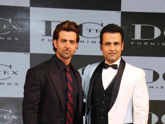I am hungry now, Rohit stop smiling! Hrithik Roshan and Rohit Roy strike a pose during a corporate event in Mumbai on October 20, 2015. (AFP)