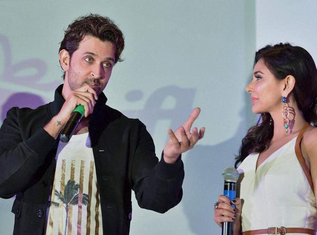Og chuck everything, hand me a burger please? Hrithik Roshan speaks as Lisa Ray looks on during the launch of e-commerce website SendMyGift in Bengaluru on Wednesday. (PTI)