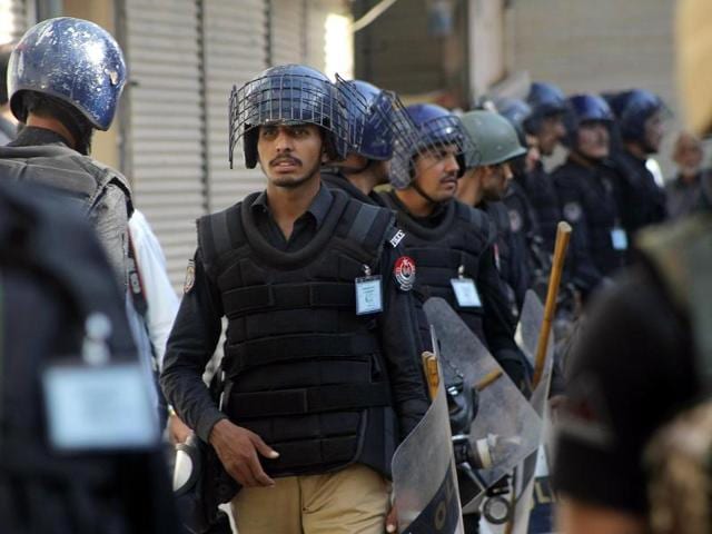 Pakistani police officers guard a Shiite procession during Muharram in Peshawar, Pakistan, on Thursday. A government official said a powerful bomb at a Shiite mosque in southwest Pakistan killed many. (AP) Pakistani police officers guard a Shiite procession during Muharram in Peshawar, Pakistan, on Thursday. A government official said a powerful bomb at a Shiite mosque in southwest Pakistan killed many. (AP)