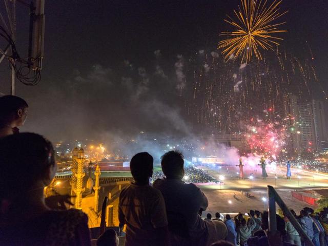 Residents from Old Delhi’s Turkman Gate watch Dussehra festival celebrations from a rooftop near Ramlila grounds, just before giant effigies of Ravana, Kumbhakaran, and Meghnad were set ablaze in a symbolic act of victory of good over evil on Thursday. (Gurinder Osan/ Hindustan Times)