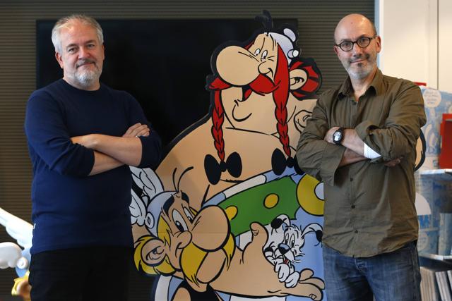 Author Jean-Yves Ferri (R) and illustrator Didier Conrad (L) pose next to cardboard cut-out of Obelix and Asterix in Vanves, near Paris, France, October 13, 2015. (REUTERS) Author Jean-Yves Ferri (R) and illustrator Didier Conrad (L) pose next to cardboard cut-out of Obelix and Asterix in Vanves, near Paris, France, October 13, 2015. (REUTERS)