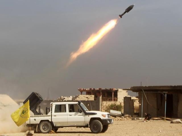 Iraqi Shiite fighters from the Popular Mobilisation units, fighting alongside Iraqi forces, fire a rocket during a military operation against Islamic State. (AFP) Iraqi Shiite fighters from the Popular Mobilisation units, fighting alongside Iraqi forces, fire a rocket during a military operation against Islamic State. (AFP)